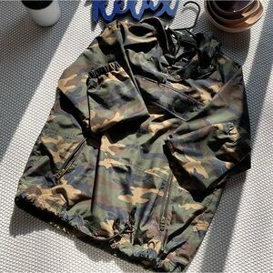 Camo wind breaker jacket with draw strings.